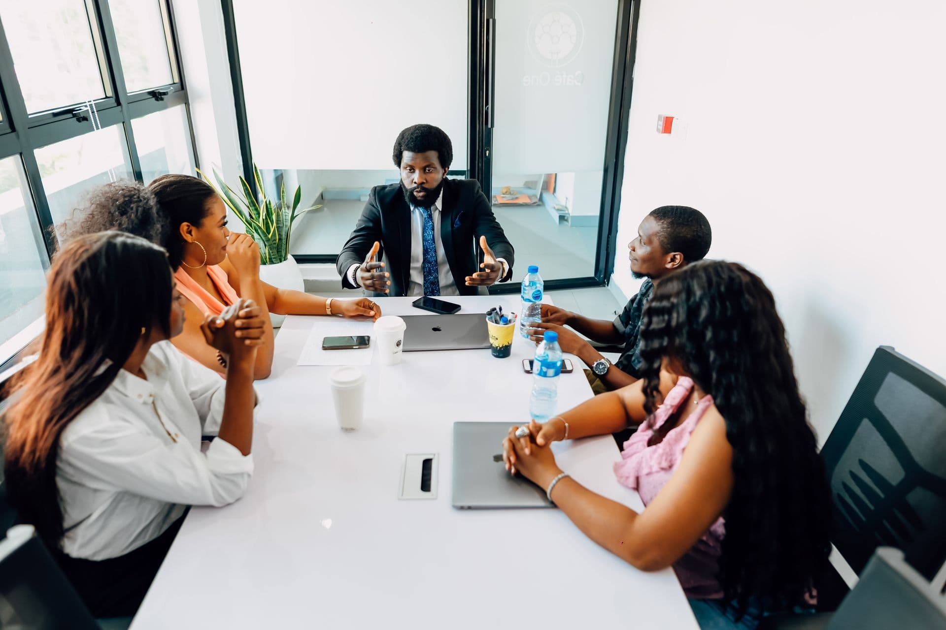 Colleagues in a meeting around a table in a Lagos office.